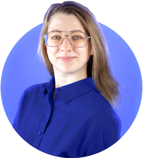 Michelle Blanchette smiling in professional attire on a bright blue background